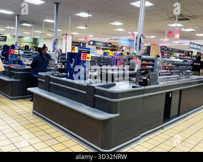 Manchester, UK - September 29, 2025: Busy Manchester supermarket checkout area with cashiers, scanners, and displays. Stock Photo