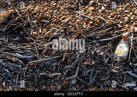 Plastic bottle washed up on the shoreline Stock Photo