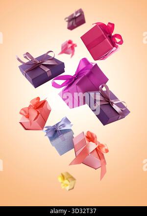 Gift boxes flying in air on coral gradient background Stock Photo