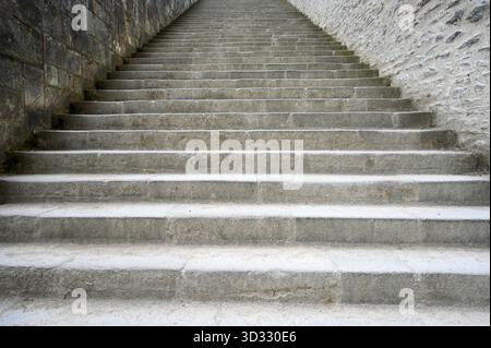 Perspective of concrete stairway with stone walls as background, for conceptual ideas Stock Photo