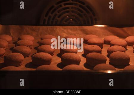 A batch of baked cookies on a baking sheet Stock Photo