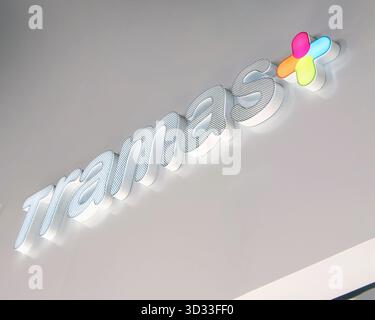 Close-up of illuminated Tramas + store sign with colorful logo on modern white wall exterior palma mallorca Stock Photo