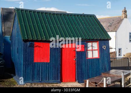vintage colourful quayside wooden hut or shack at st abbs harbour, scottish borders scotland Stock Photo
