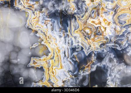 Abstract natural stone texture with intricate blue, gray, and orange patterns Stock Photo