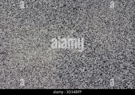 Texture of gray spotted granite, natural polished stone, Ukrainian granite noisy texture Stock Photo