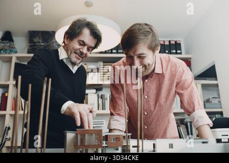 Architects with blueprints and layout design project at office bureau Stock Photo