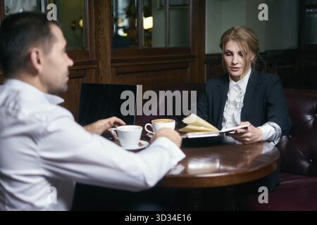 Business people talking over coffee in a cafe Stock Photo