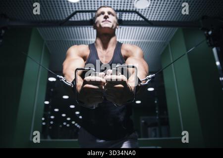 Close-up of focused man', s hand doing exercise in gym Stock Photo