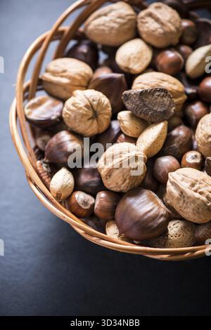Mixed whole nuts in basket, border background Stock Photo