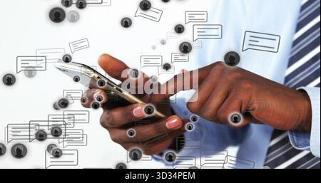 Tapping man wearing tie holding smartphone against white backdrop, with chat bubbles and avatars Stock Photo