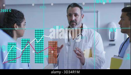 Pointing doctor with coat, stethoscope holding yellow folder in hospital corridor, with data charts Stock Photo