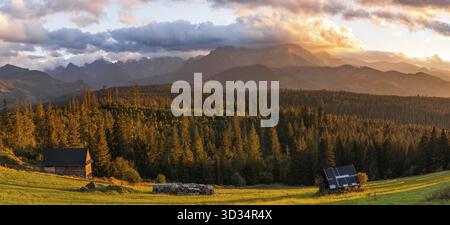 Panorama of Sunset in Carpathian Mountains. Golden Hour light over nature landscape Stock Photo