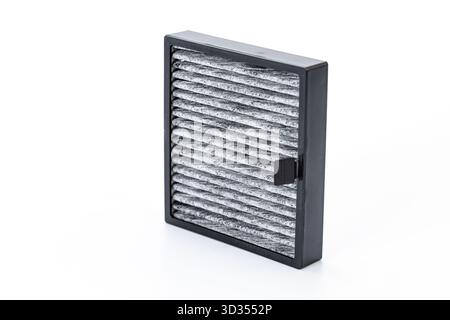The replaced car air filter reveals a clear difference between the dirty, dust-covered air intake side and the cleaner air outlet side Stock Photo