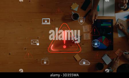An overhead view of a professional workspace with warning icons related to security and data protection, emphasizing teamwork and technology during a Stock Photo