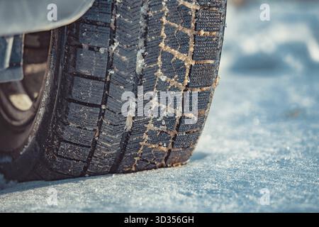Car tire on snow at winter close-up view Stock Photo