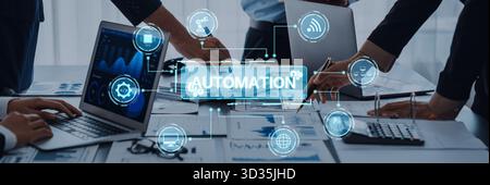 A modern office scene showing a collaborative meeting focused on automation strategies, featuring laptops and digital interfaces, highlighting Stock Photo