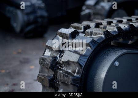 Heavy-duty excavator track tread with visible traction profile and reinforced rubber structure designed for grip and terrain durability in compact mac Stock Photo