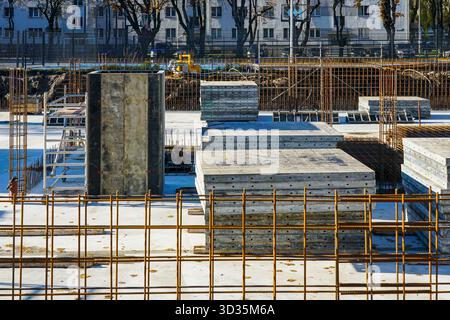 Liepaja, Latvia- November 01, 2025: Concrete foundation work with rebar reinforcement at apartment building construction site Stock Photo