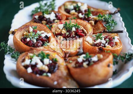 Baked pears with Feta cheese, walnuts, thyme and cranberries. . Front view. Stock Photo