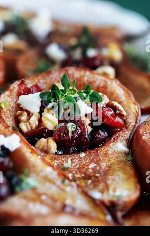 Baked pears with Feta cheese, walnuts, thyme and cranberries. Selective focus with blurred background. Stock Photo