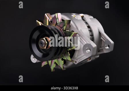 car generator close-up, element of the car power supply system, on a black background, close-up, selective focus Stock Photo