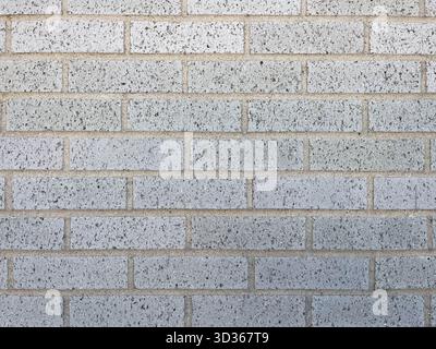 Texture of baked earth-colored bricks on a wall Stock Photo