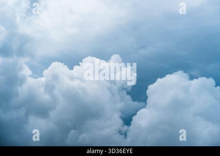 Towering cumulus clouds fill the sky, creating a powerful and dramatic view of nature's atmosphere and beauty. Stock Photo