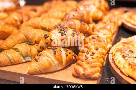 Delicious sweet pastries, croissants, on display in a cafe Stock Photo
