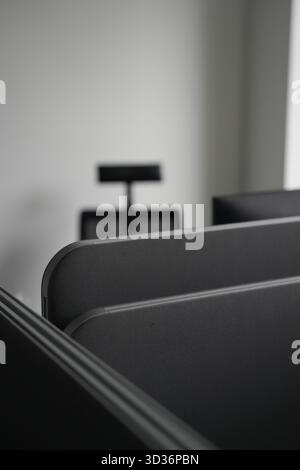 A close-up shot of a modern office interior, featuring dark furniture and a minimalist design. Stock Photo