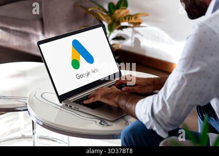 Man using a laptop showing Google Ads on the screen. Rosario, Argentina - November 4, 2025. Stock Photo