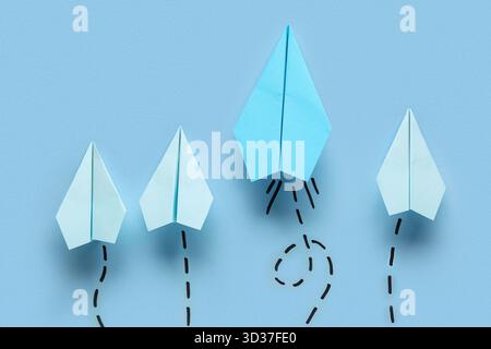 Paper planes with dotted lines on blue background Stock Photo