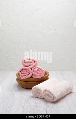 Pink folded towels on a light background, top view, offering a clean mockup for design with room for text and branding. Stock Photo