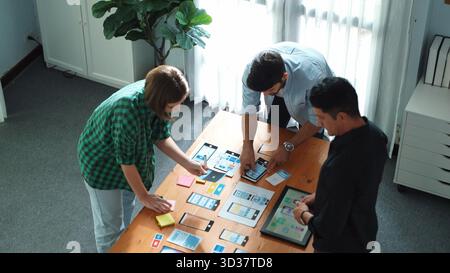 Top view of smart Ui designer brainstorming and planning about Ux Uo design or mobile interface wireframe design with diverse develop team. Caucasian Stock Photo