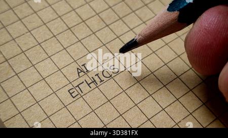 AI Ethics Concept Word Written on Grid Paper with Pencil for Artificial Intelligence Discussion Stock Photo