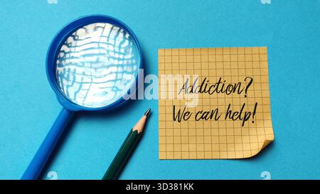 "Addiction? We can help!" message on sticky note symbolizing hope, support, and seeking professional assistance for recovery. Stock Photo