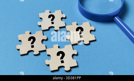 Searching for Answers and Solving Problems Concept with Puzzle Pieces Stock Photo