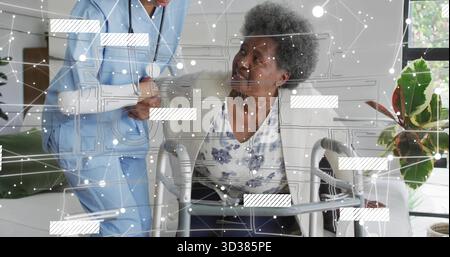 Using walker senior wearing cardigan at home by sofa, with caregiver holding stethoscope Stock Photo