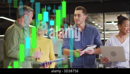 Reviewing holographic charts on tablet four analysts in business shirts standing in open office Stock Photo