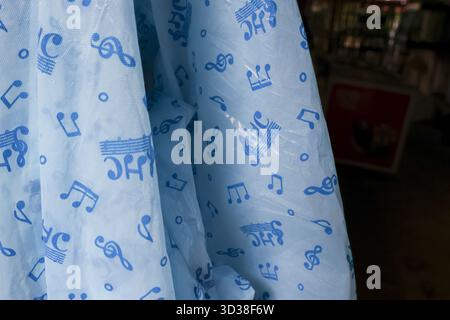 Gentle light blue fabric with whimsical pattern of music note and crown. This soft textile background has playful and charming print perfect for nurse Stock Photo