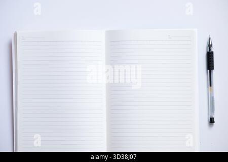 Close-up of blank notebook and pen isolated on white background Stock Photo