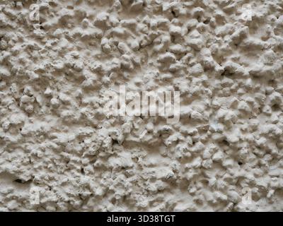 Trowel-applied plaster with a large grain size. Textured wall surface in a light tone. Copyspace. Stock Photo