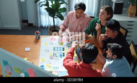 Top down view of business team putting hand together while discussing about Ux Ui design for mobile phone at boardroom. Close up of marketing team Stock Photo
