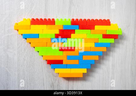 Assembled multi-colored plastic construction blocks lie on the floor. Stock Photo