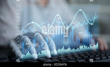 A robotic hand interacts with digital graph visualizations on a keyboard, illustrating advanced AI technology in data analysis and business strategy Stock Photo