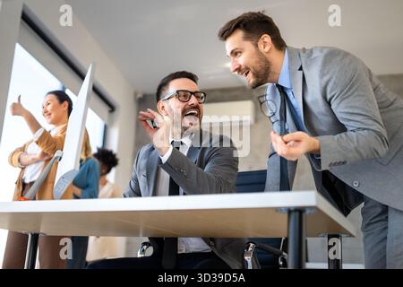 Team of programmers writing digital code in the metaverse and working together on the internet Stock Photo
