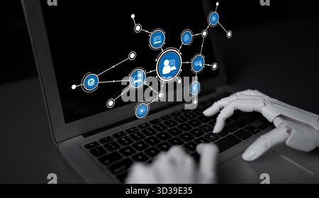 A robotic hand typing on a laptop, surrounded by digital connection icons, symbolizes the integration of technology and human interaction in the Stock Photo