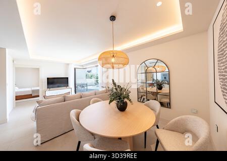 Modern living room with dining area and sofa in luxury holiday home Stock Photo