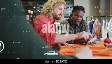 Two designers examining orange garment sample in retail showroom, with smartphone and data graphics Stock Photo