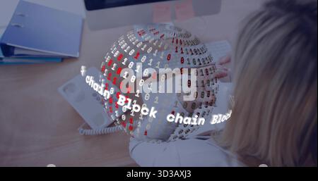 Office worker wearing blouse typing in office, with block chain graphic, copy space Stock Photo