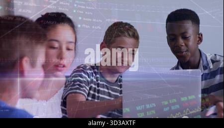 Working four students collaborating using laptop on table in bright study room, with chart overlays Stock Photo
